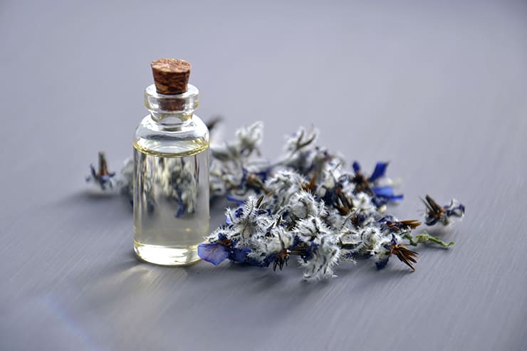 Pile of flowers beside a bottle